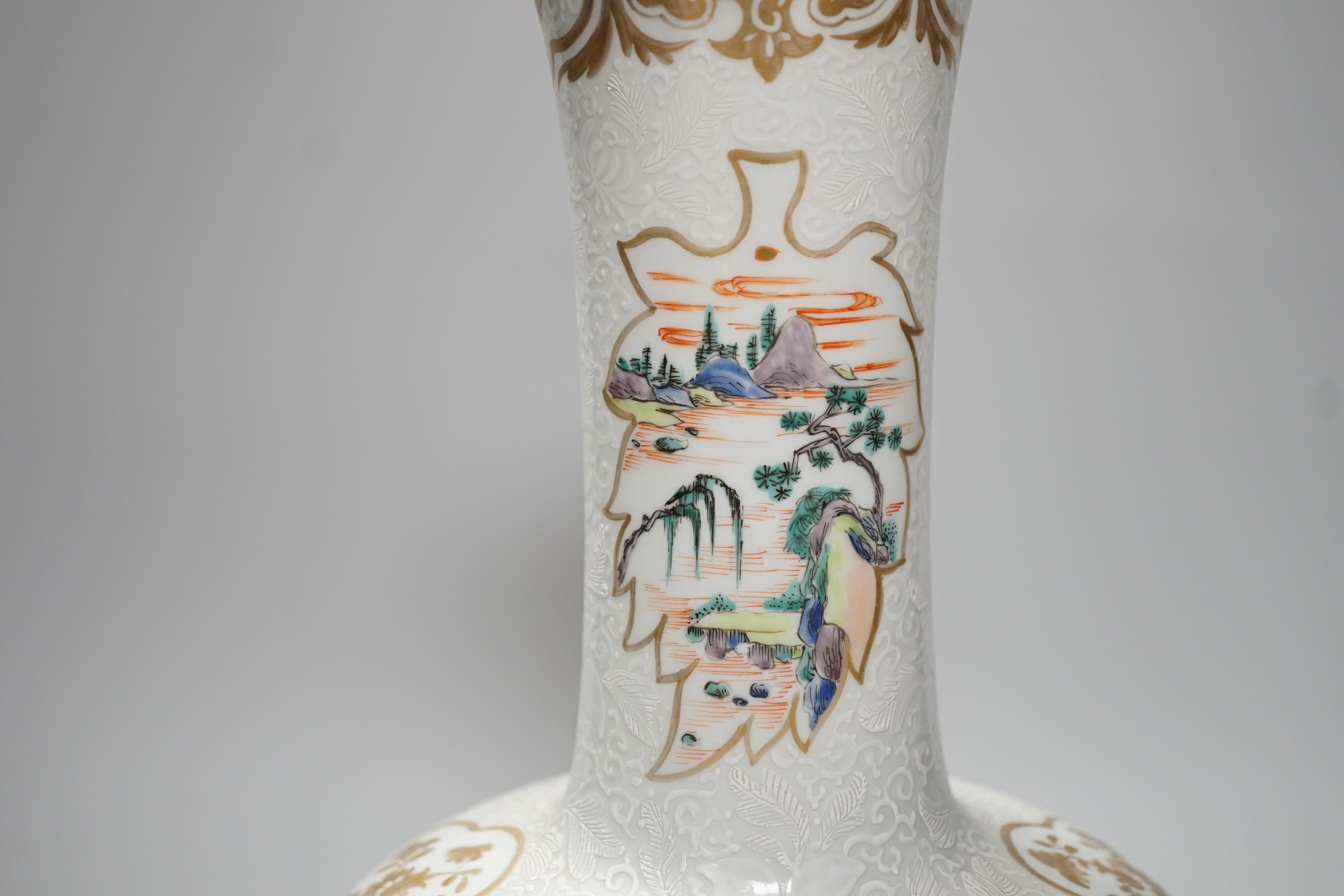 A Chinese enamelled porcelain bottle vase, 36cm, with bianco sopra bianco borders, base drilled